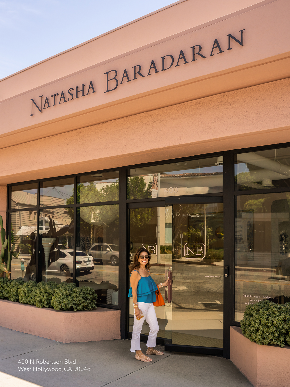 Natasha opening the glass doors to her flagship showroom