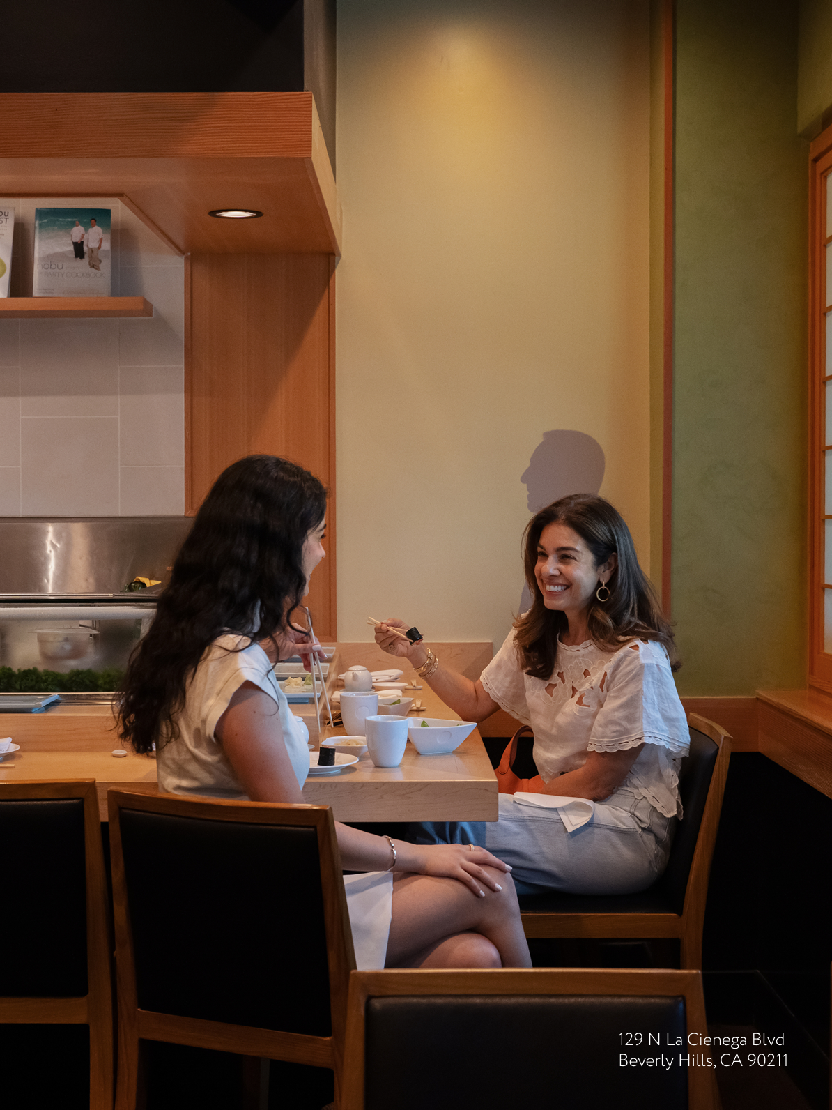 Natasha enjoying sushi with a friend at Matsuhisa